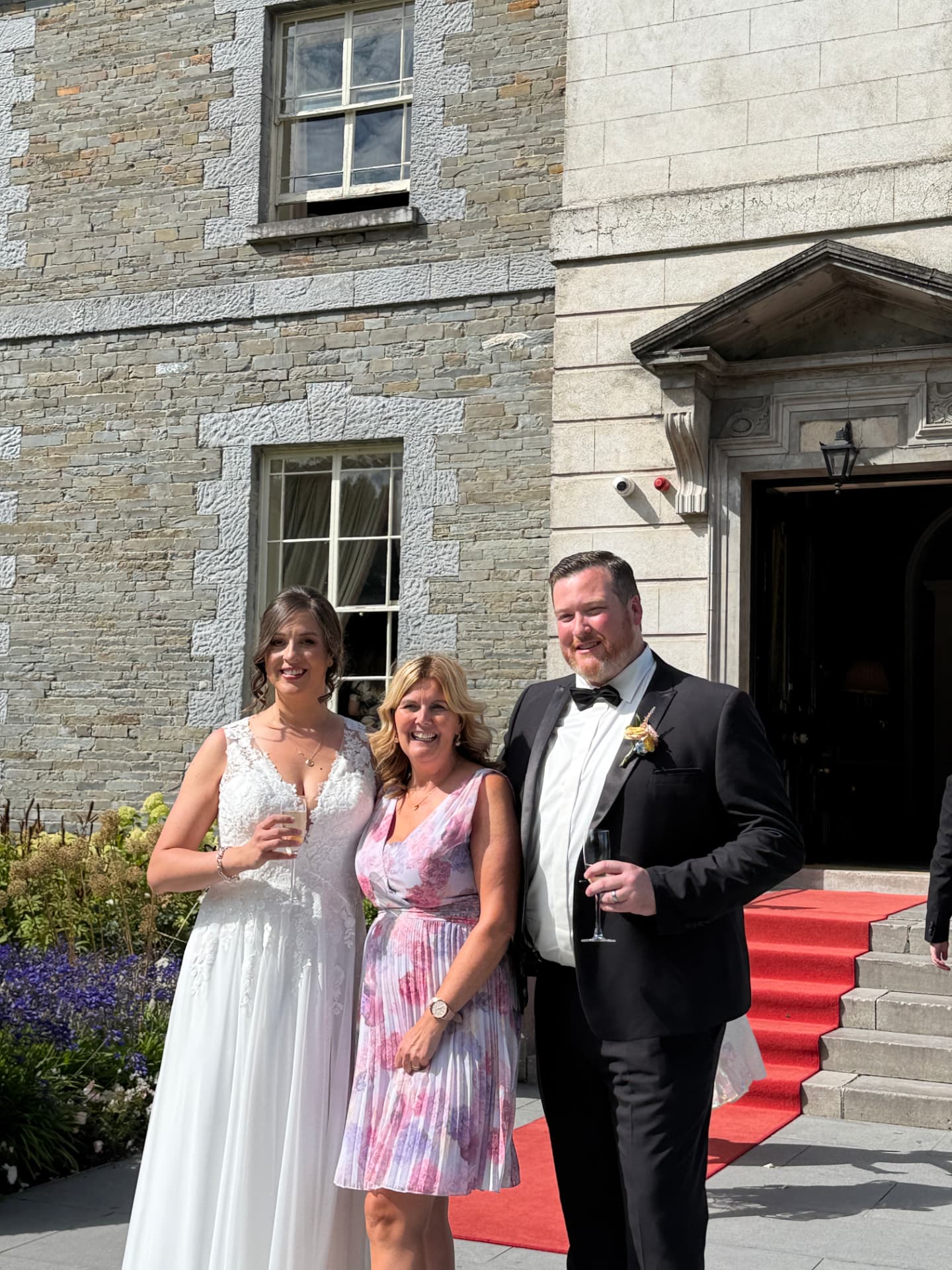 Laure and Dan with Grá outside the stone country house after the ceremony