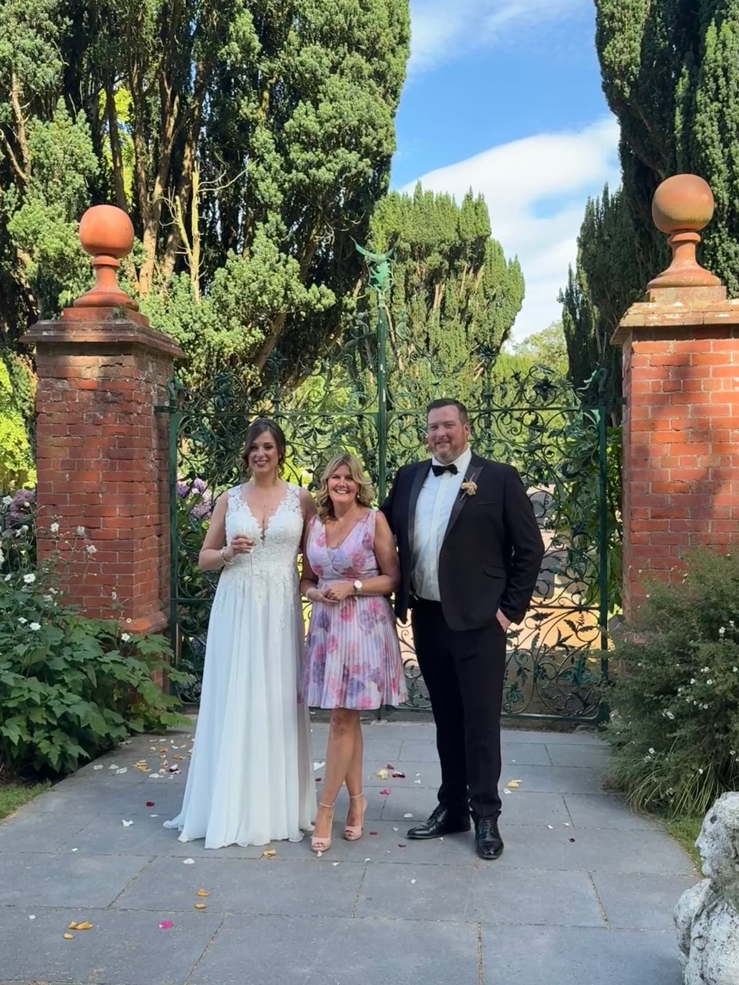 Laure and Dan with Grá at the wrought iron garden gate